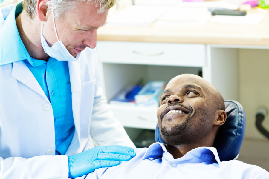 male dental patient gets a routine exam from the dentist, dentist in bentonville