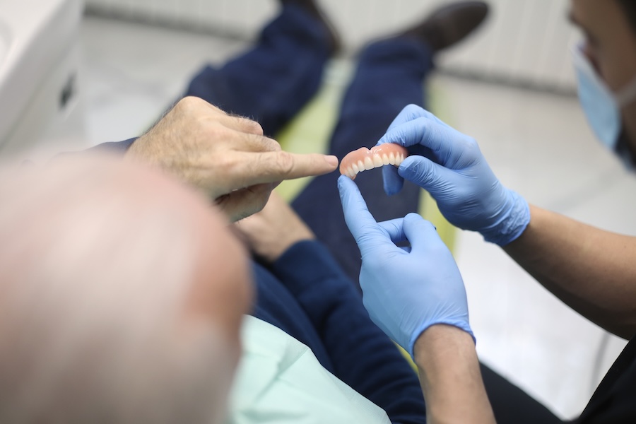 food stuck under denture